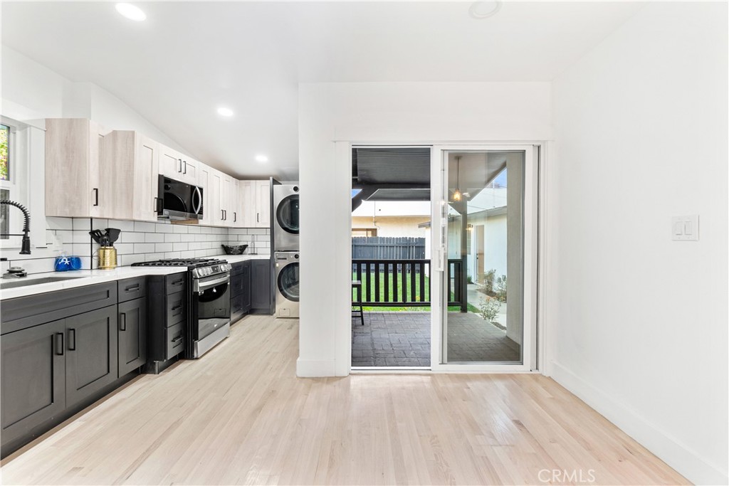 1148 Locust Avenue Long Beach, CA 90813 - Photo 10 of 34 a open kitchen with stainless steel appliances a stove top oven a sink dishwasher and a refrigerator with wooden floor