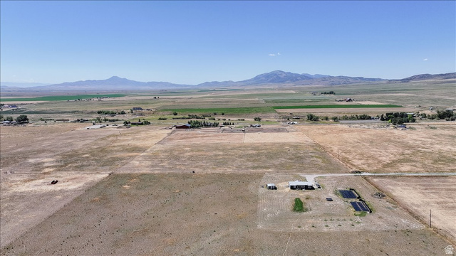 1634 West Arimo Road Arimo, ID 83214 - Photo 68 of 89 Expansive rural property featuring a main residence with a light-colored roof, multiple outbuildings, and several dark-lined cultivation beds