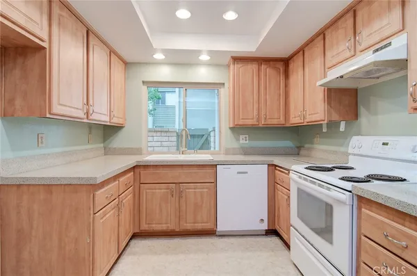 a kitchen with granite countertop cabinets stainless steel appliances and a sink