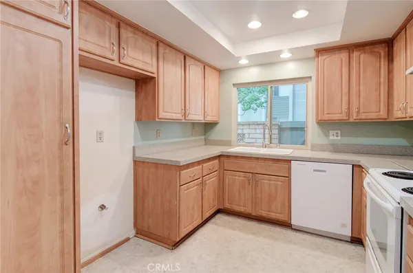 a kitchen with granite countertop cabinets sink and window