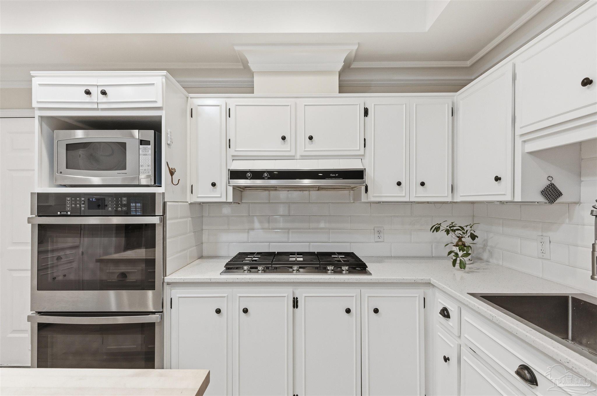 2437 West Bayshore Road Gulf Breeze, FL 32563 - Photo 17 of 62 a kitchen with cabinets and appliances