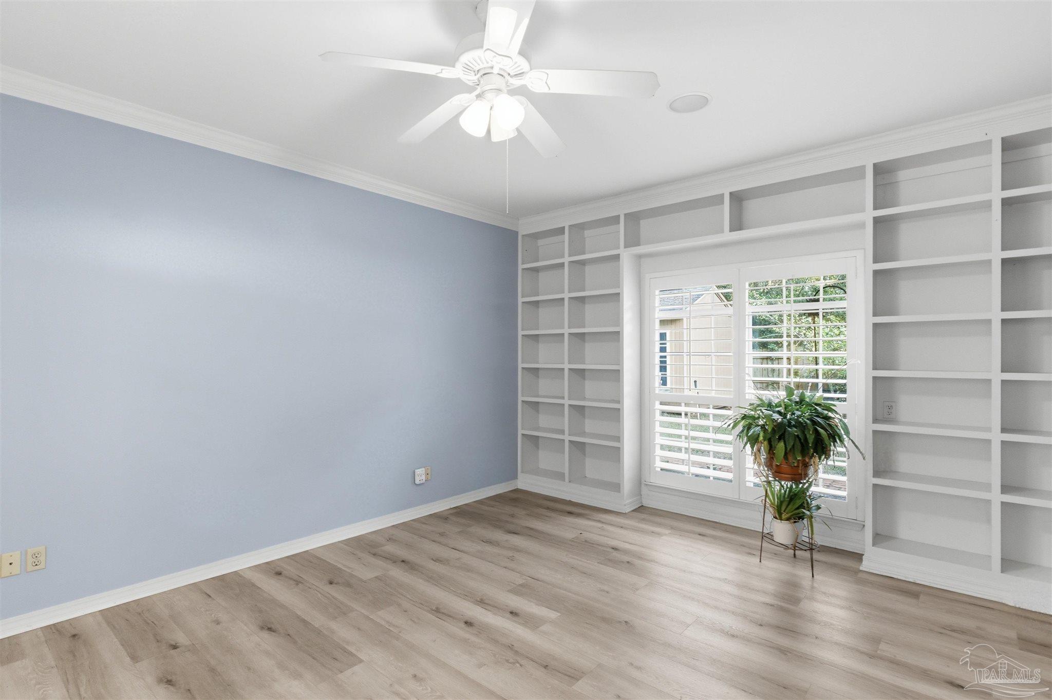 2437 West Bayshore Road Gulf Breeze, FL 32563 - Photo 21 of 62 a view of an empty room with a window and wooden floor