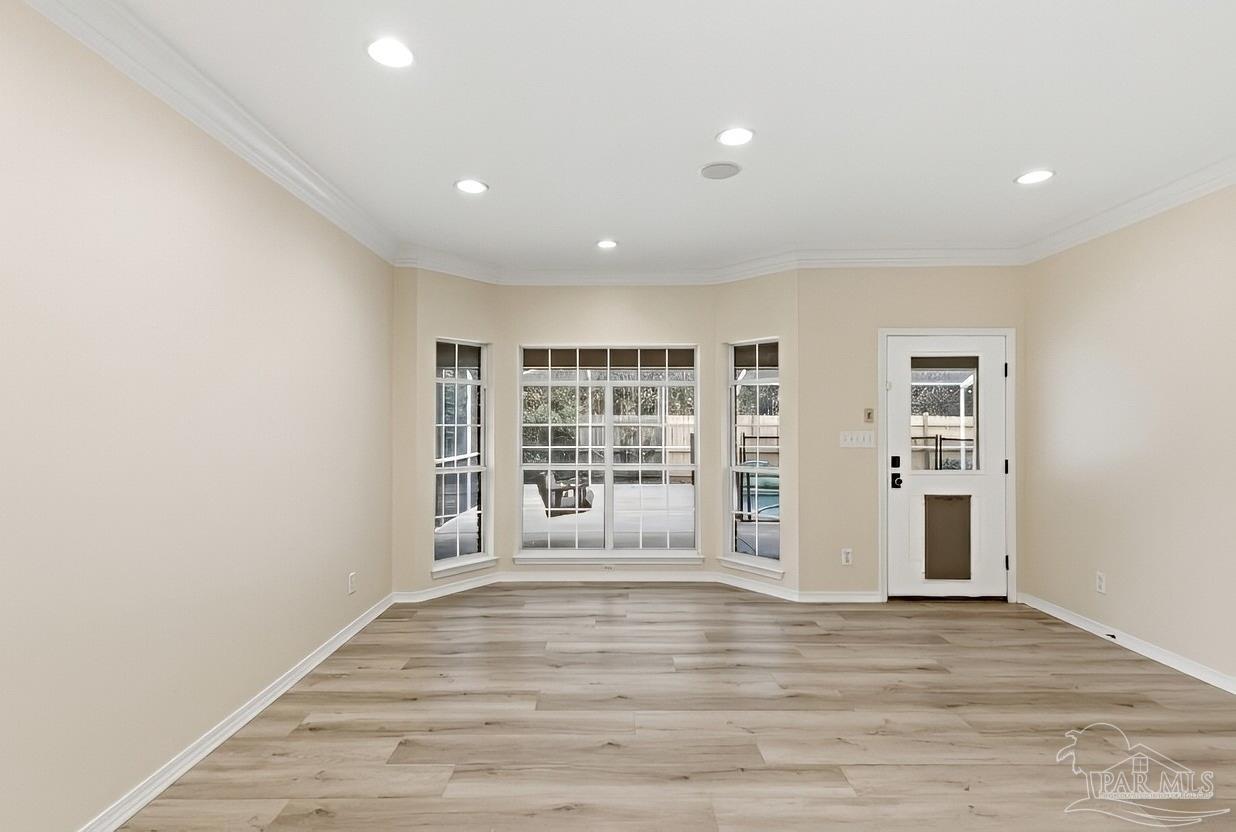 2437 West Bayshore Road Gulf Breeze, FL 32563 - Photo 5 of 62 a view of an empty room with a window and wooden floor