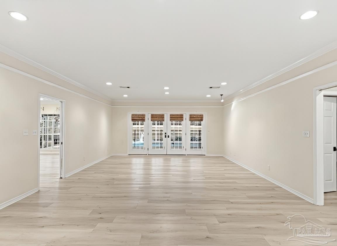 2437 West Bayshore Road Gulf Breeze, FL 32563 - Photo 10 of 62 a view of an empty room with wooden floor and a window