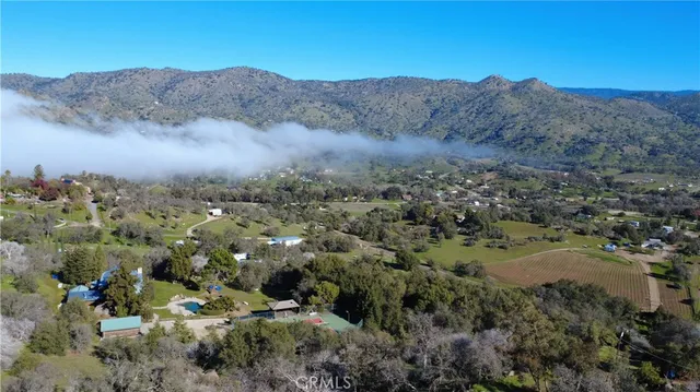 an aerial view of residential house and sandy dunes