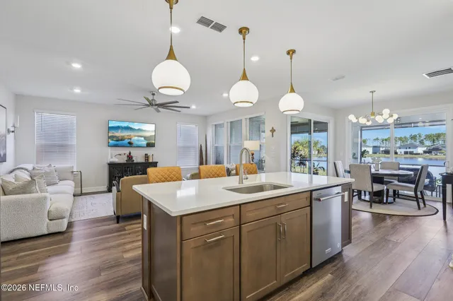 a en suite bathroom with a double vanity sink a mirror and a bathtub