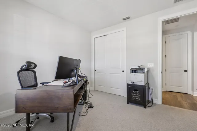 an aerial view of residential houses with yard and lake view