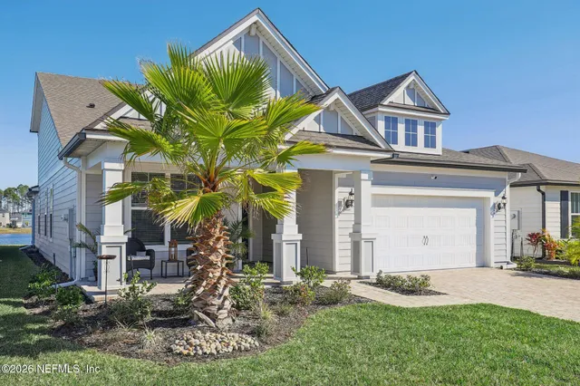 a living room with furniture kitchen view and a large window