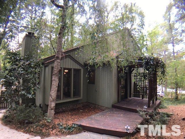 504 Merrie Road Raleigh, NC 27606 - Photo 1 of 25 a view of a wooden house with a large tree
