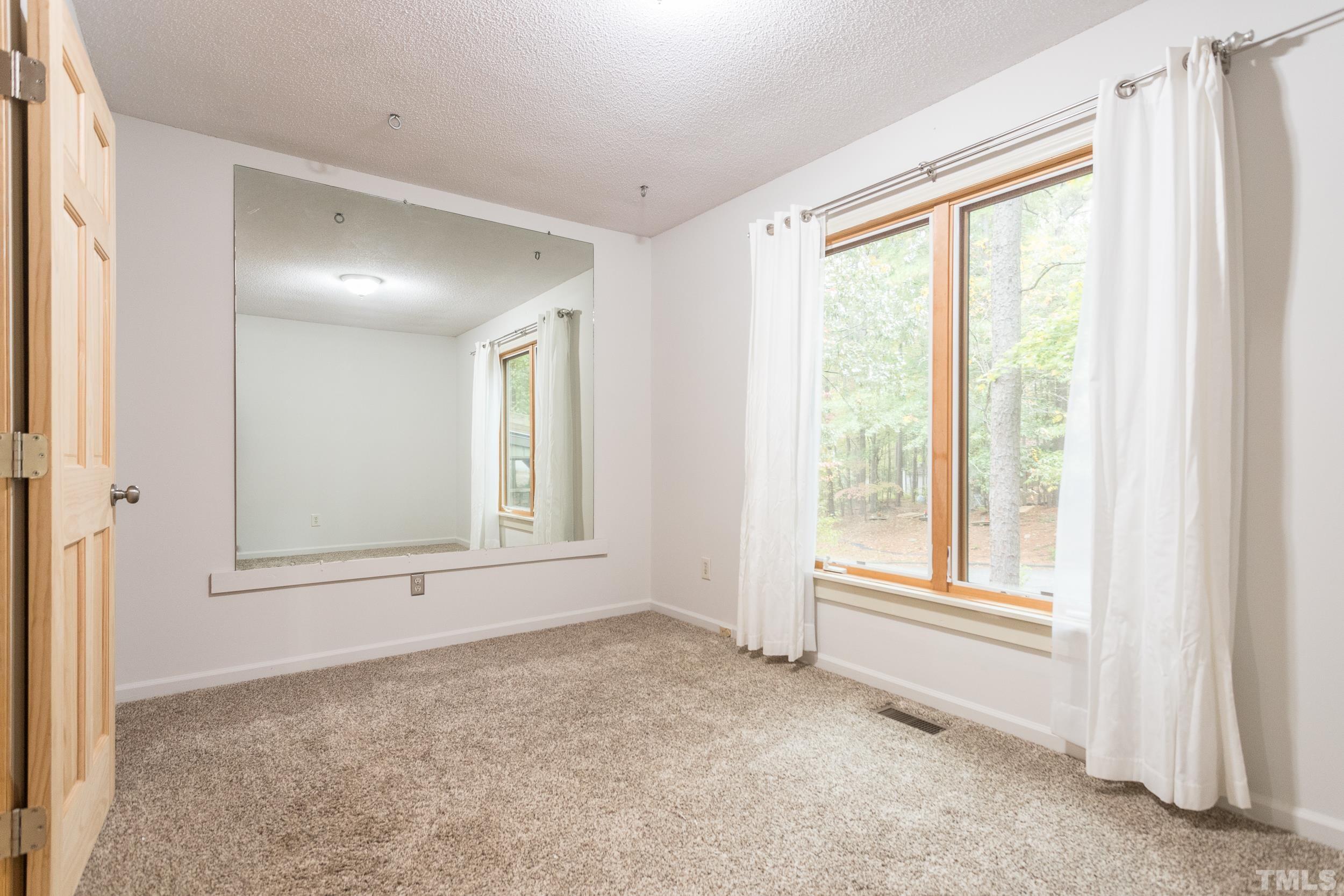 504 Merrie Road Raleigh, NC 27606 - Photo 13 of 25 a view of an empty room with a window