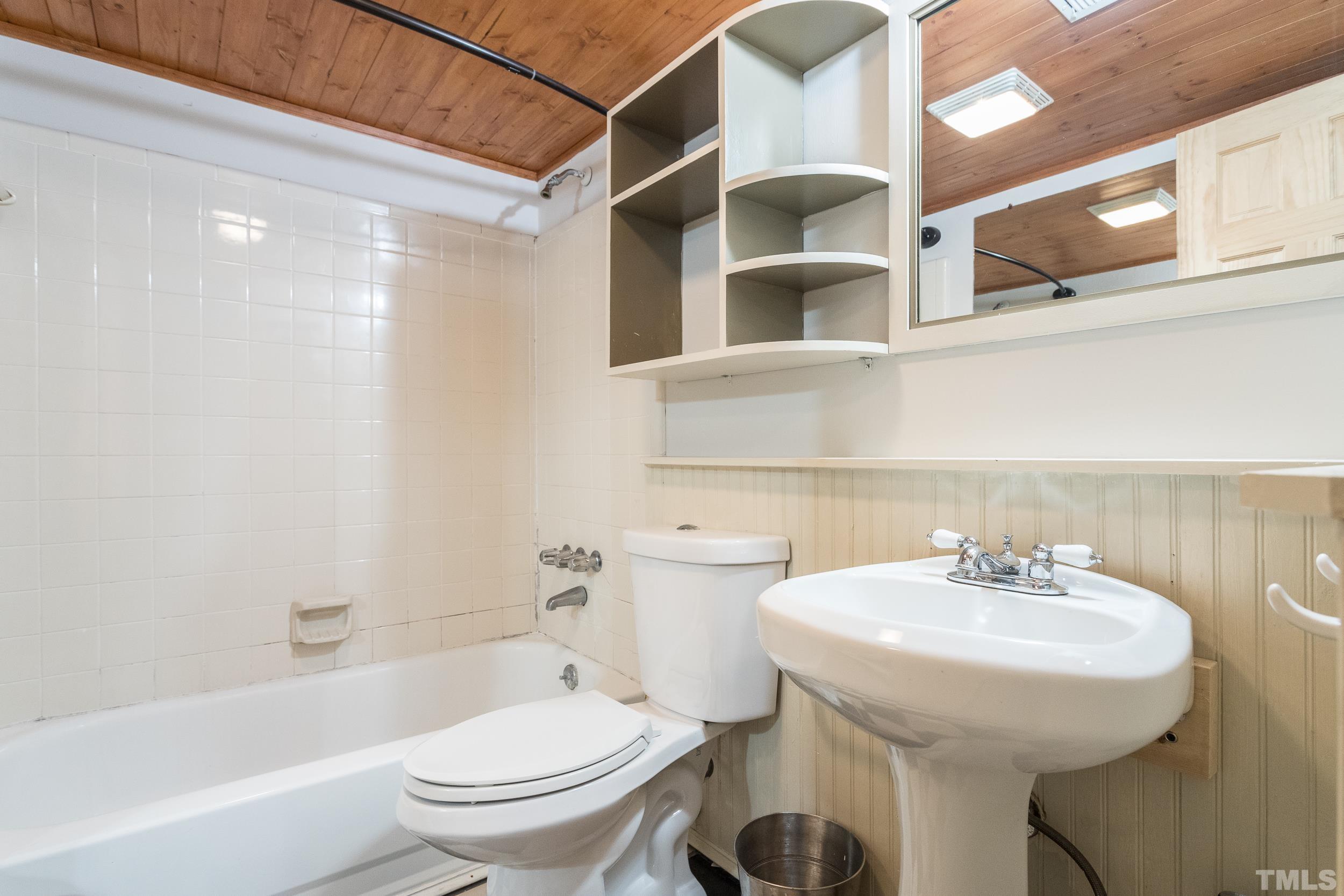 504 Merrie Road Raleigh, NC 27606 - Photo 19 of 25 a bathroom with a sink toilet and shower