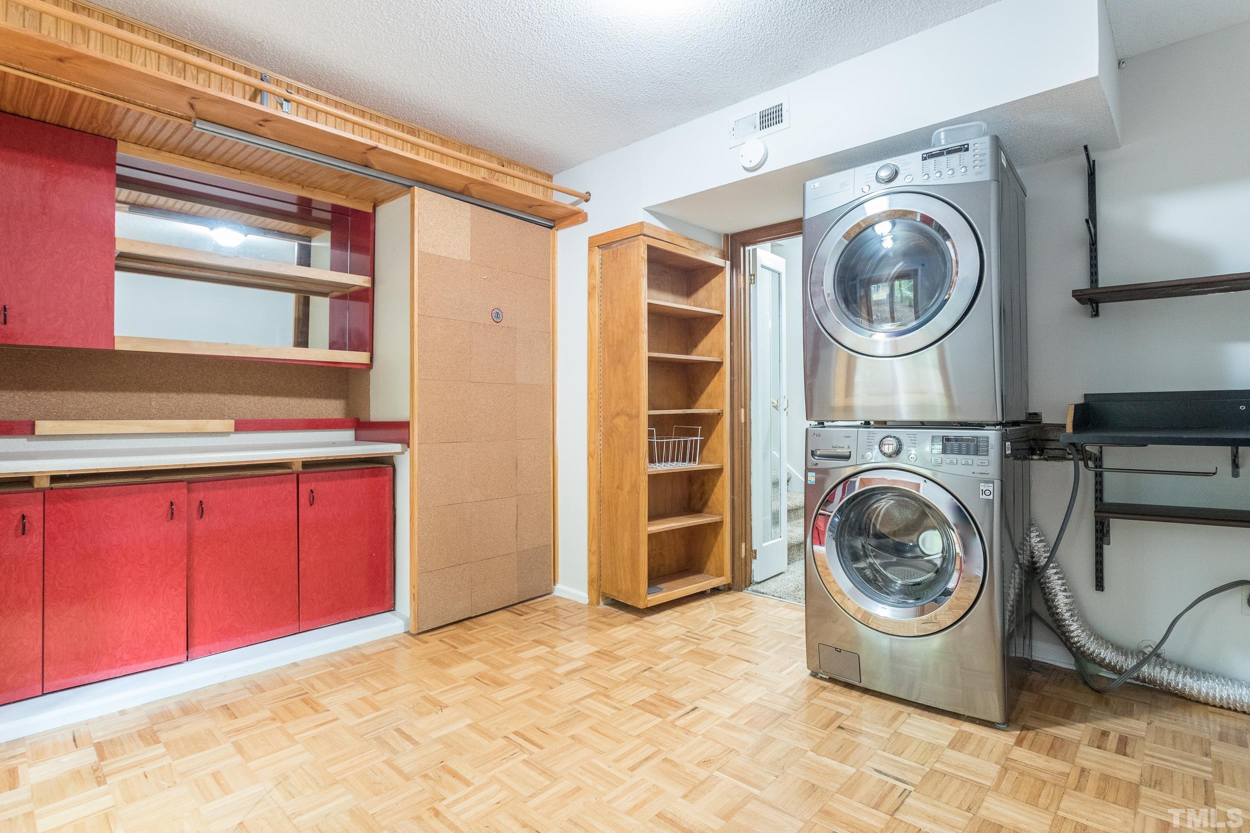 504 Merrie Road Raleigh, NC 27606 - Photo 20 of 25 a view of a storage and utility room with washer and dryer