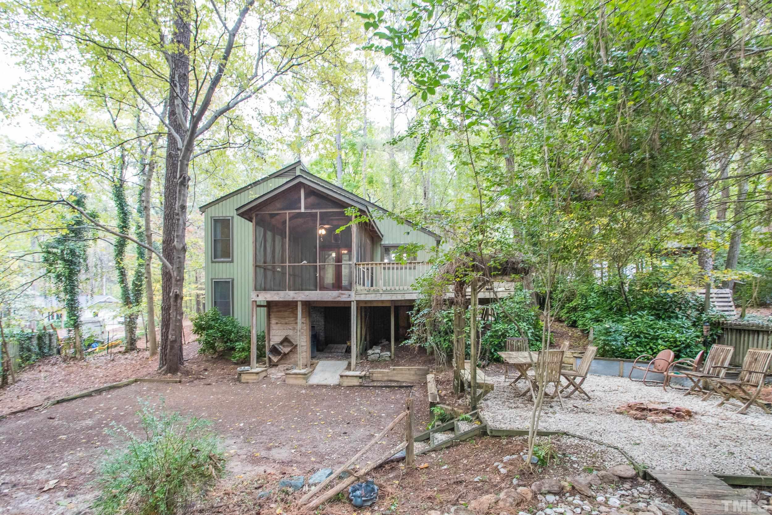 504 Merrie Road Raleigh, NC 27606 - Photo 23 of 25 a front view of house with yard and seating area