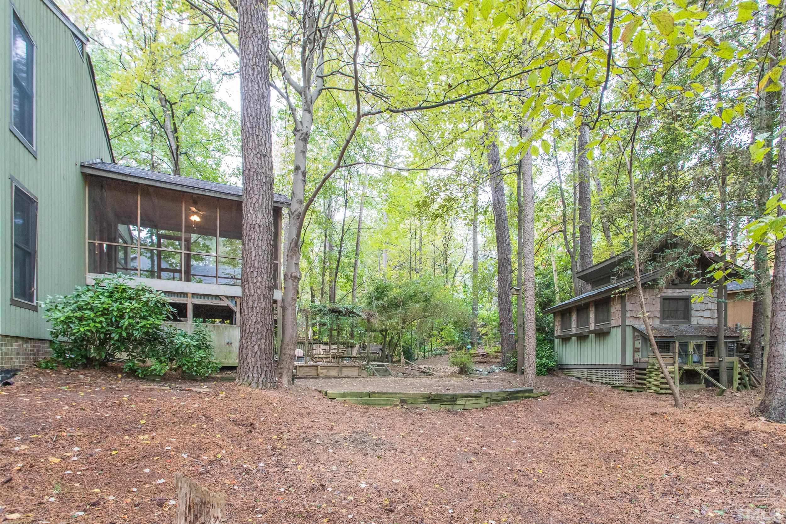 504 Merrie Road Raleigh, NC 27606 - Photo 25 of 25 a view of a house with large trees and plants