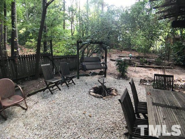 504 Merrie Road Raleigh, NC 27606 - Photo 5 of 25 a view of backyard with seating space and trees in the background