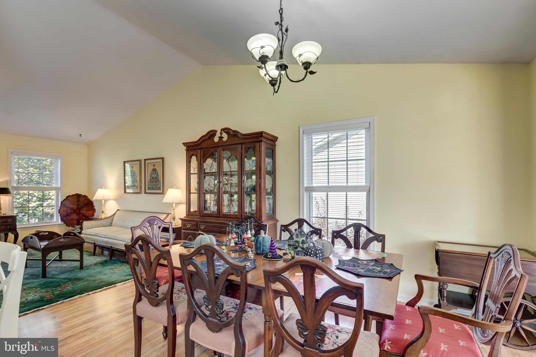 314 Huntinghorn Street Taneytown, MD 21787 - Photo 14 of 47 a view of a dining room with furniture a chandelier and wooden floor