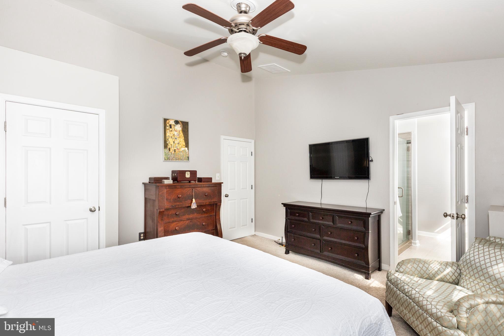 314 Huntinghorn Street Taneytown, MD 21787 - Photo 28 of 47 a bedroom with a bed and a flat screen tv
