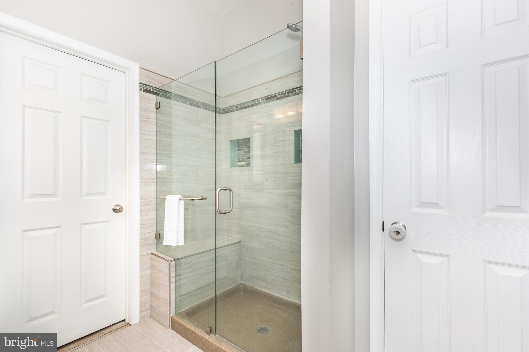 314 Huntinghorn Street Taneytown, MD 21787 - Photo 31 of 47 a bathroom with a glass shower door