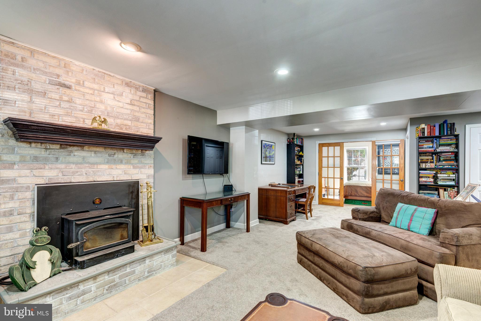 314 Huntinghorn Street Taneytown, MD 21787 - Photo 42 of 47 a living room with furniture a flat screen tv and a fireplace
