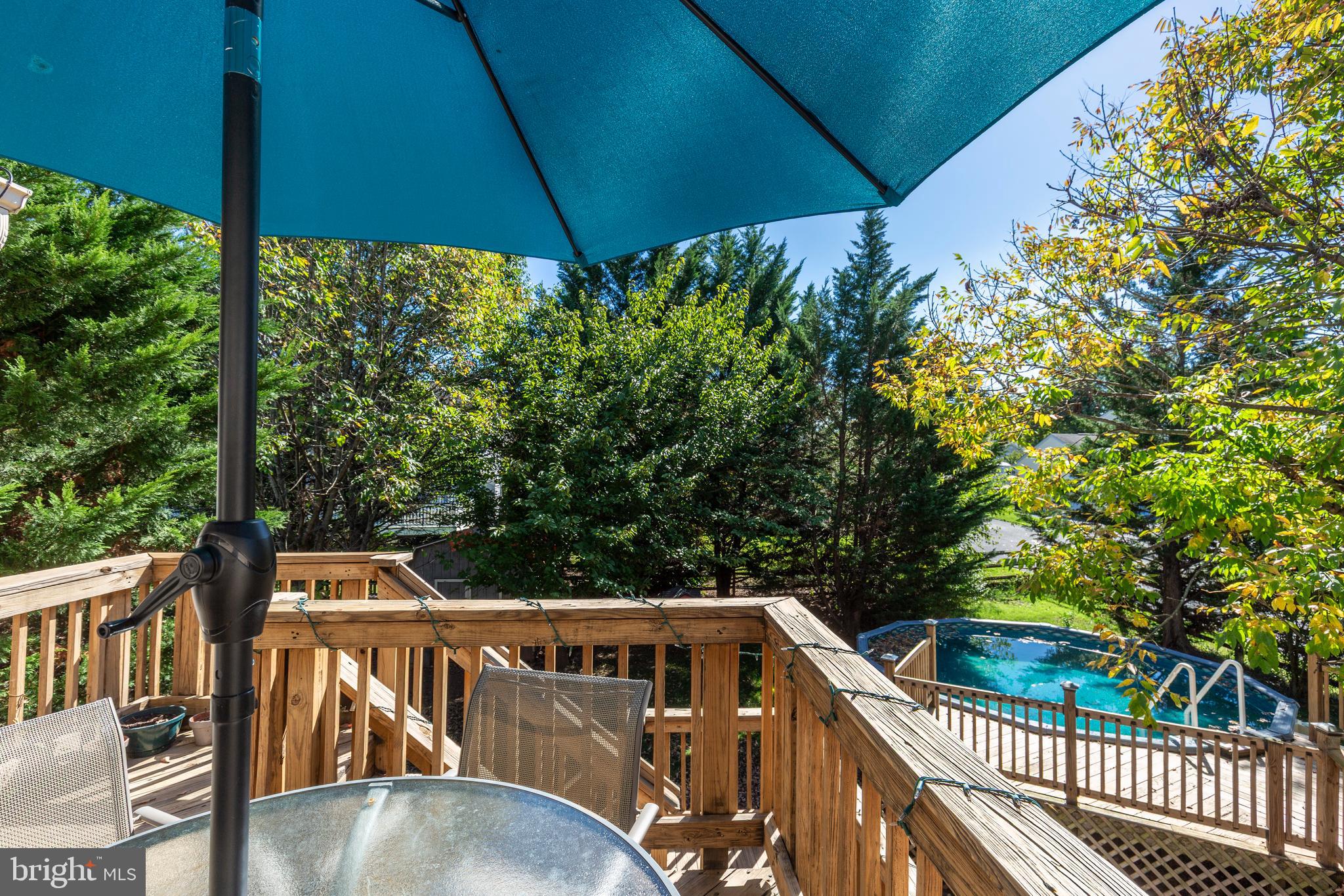 314 Huntinghorn Street Taneytown, MD 21787 - Photo 47 of 47 a view of a roof deck with table and chairs under an umbrella