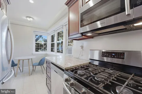 a kitchen with a stove and a refrigerator
