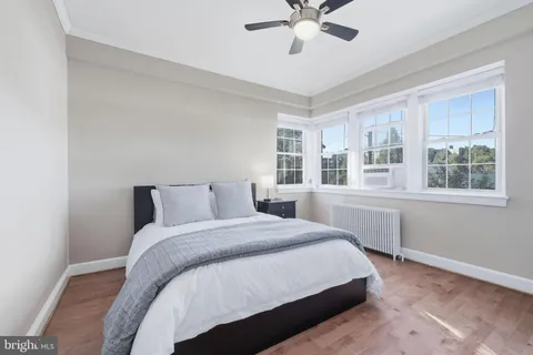 a bedroom with a large bed and a window