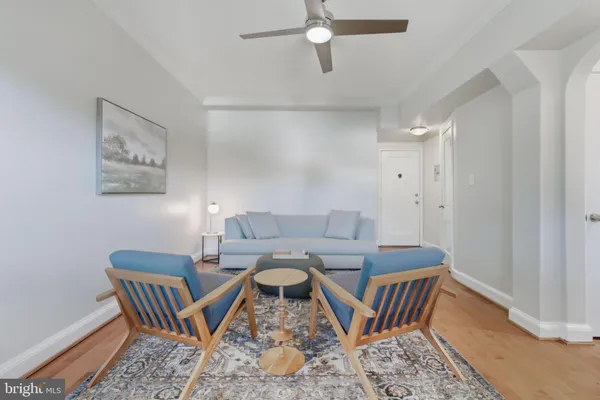 a dining room with furniture and wooden floor
