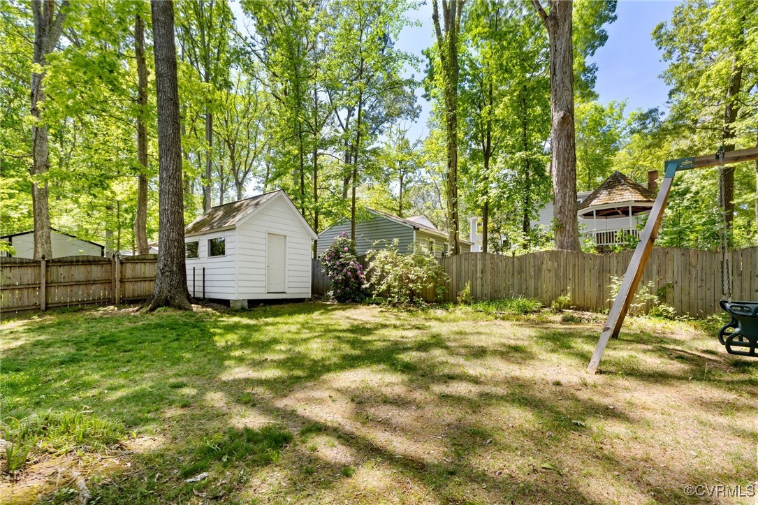 12907 Ashtree Road Midlothian, VA 23114 - Photo 30 of 32 a backyard of a house with a table and chair