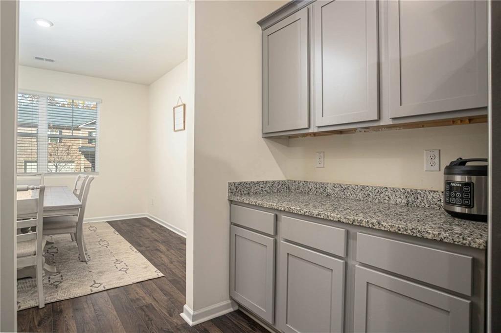 5381 Flat Rock Point Stonecrest, GA 30038 - Photo 13 of 53 a kitchen with granite countertop white cabinets and white appliances
