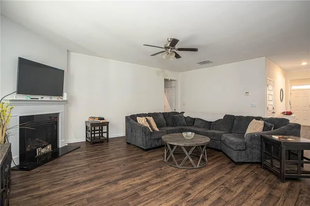 a living room with furniture a fireplace and a flat screen tv