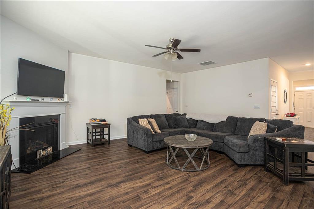 5381 Flat Rock Point Stonecrest, GA 30038 - Photo 14 of 53 a living room with furniture a fireplace and a flat screen tv