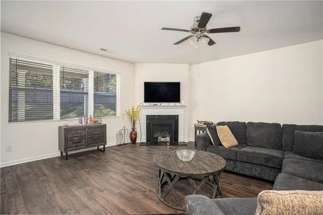 a living room with furniture and a view of kitchen