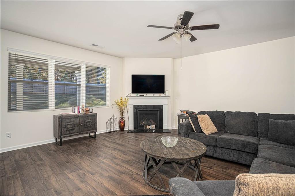 5381 Flat Rock Point Stonecrest, GA 30038 - Photo 15 of 53 a living room with furniture a fireplace and a flat screen tv