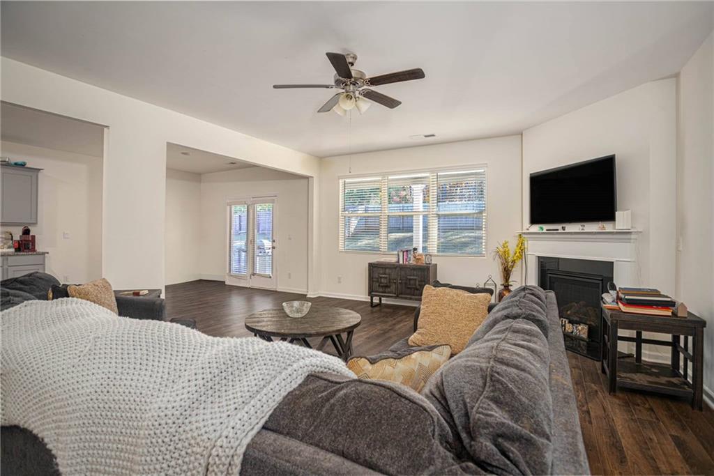 5381 Flat Rock Point Stonecrest, GA 30038 - Photo 16 of 53 a living room with furniture a fireplace and a flat screen tv