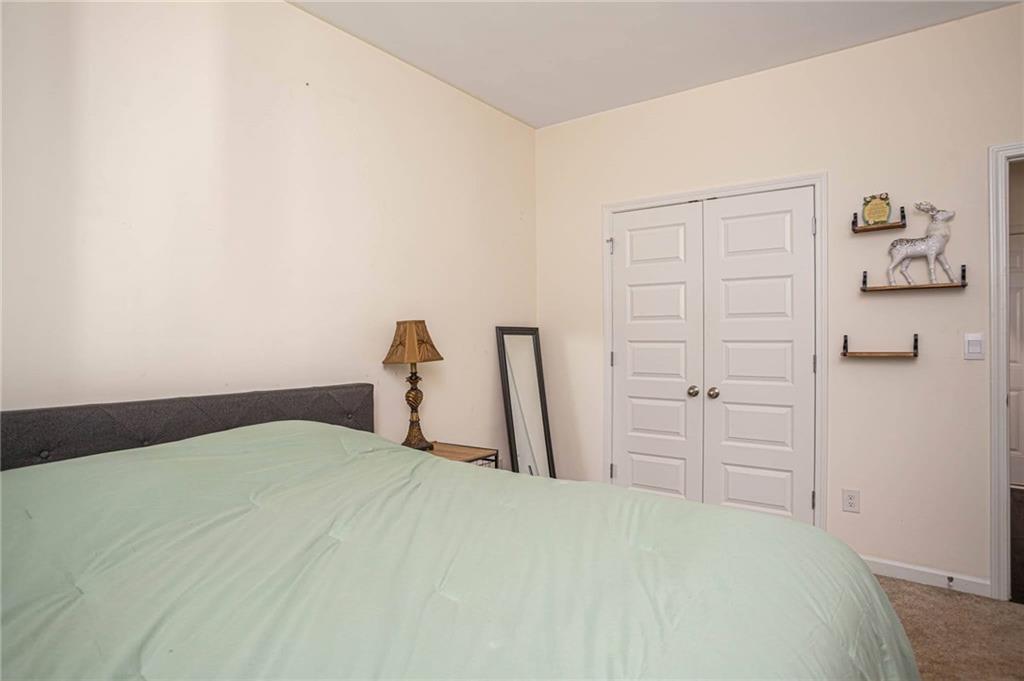 5381 Flat Rock Point Stonecrest, GA 30038 - Photo 19 of 53 a bedroom with a bed and a cabinets