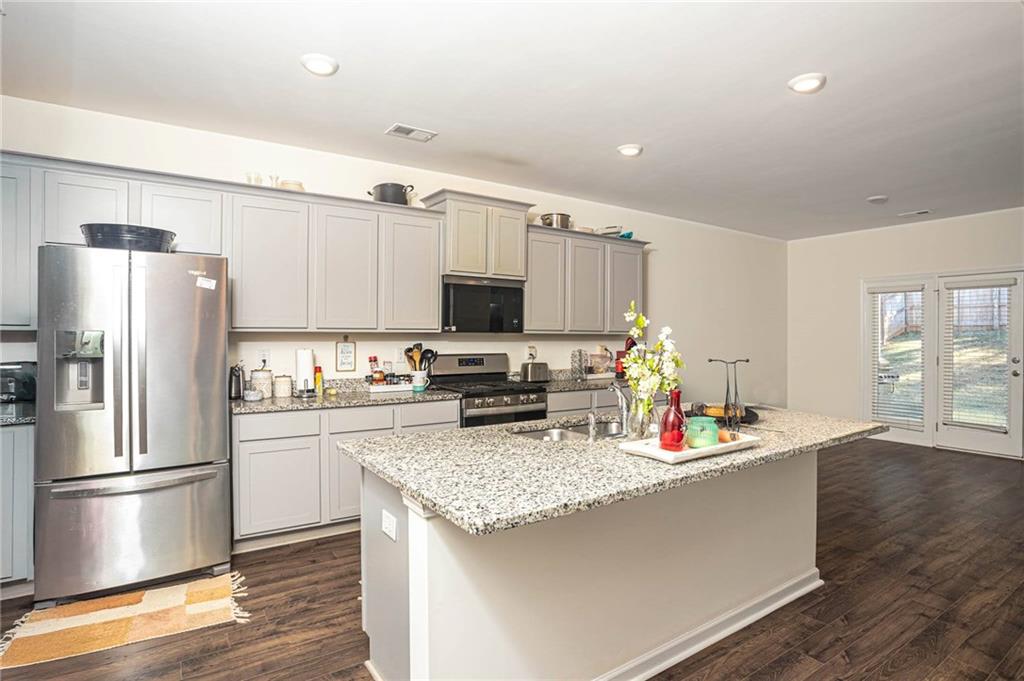 5381 Flat Rock Point Stonecrest, GA 30038 - Photo 22 of 53 a kitchen with stainless steel appliances granite countertop a refrigerator and a stove top oven