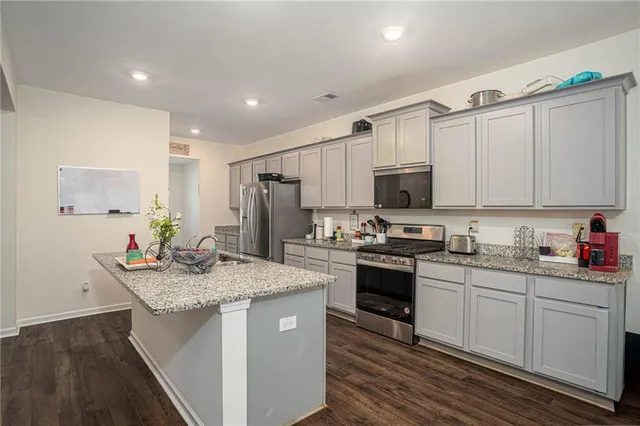 a kitchen with refrigerator and a sink