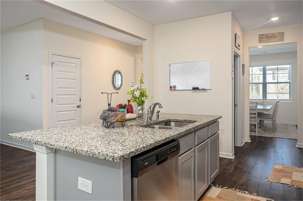 5381 Flat Rock Point Stonecrest, GA 30038 - Photo 24 of 53 a kitchen with stainless steel appliances granite countertop a sink stove and cabinets