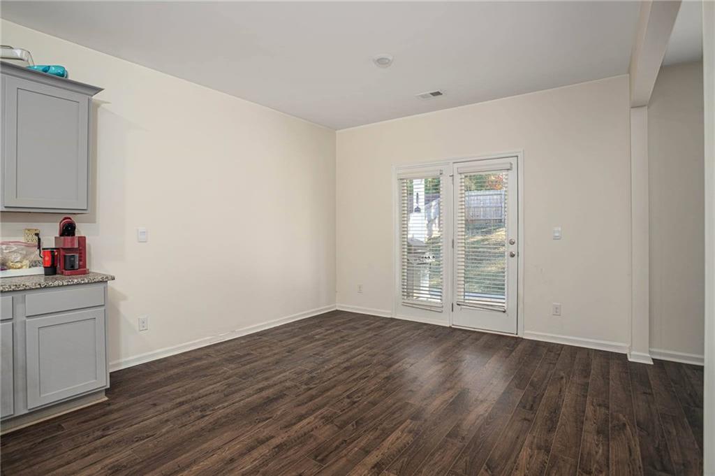 5381 Flat Rock Point Stonecrest, GA 30038 - Photo 26 of 53 a view of an empty room with wooden floor and a window