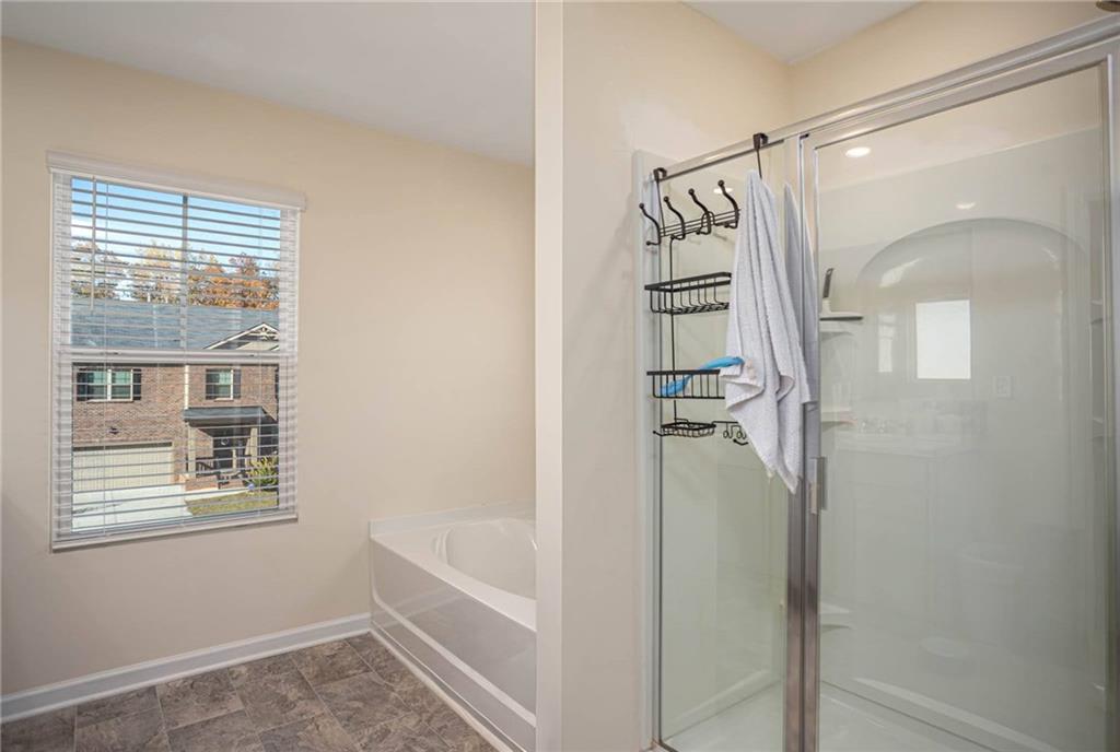 5381 Flat Rock Point Stonecrest, GA 30038 - Photo 36 of 53 a bathroom with a bathtub and a shower