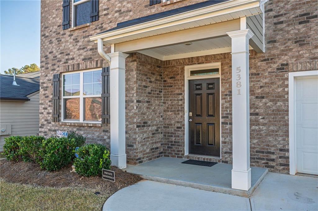 5381 Flat Rock Point Stonecrest, GA 30038 - Photo 5 of 53 front view of a brick house with a large windows