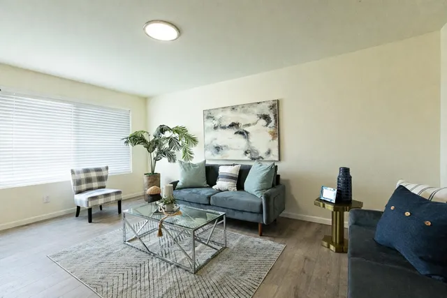 a living room with furniture and a lamp