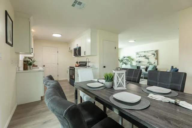 a view of a dining room with furniture and wooden floor