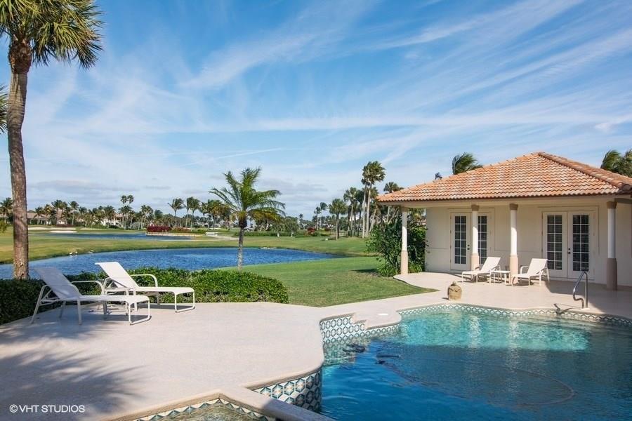 a view of a house with swimming pool and sitting area
