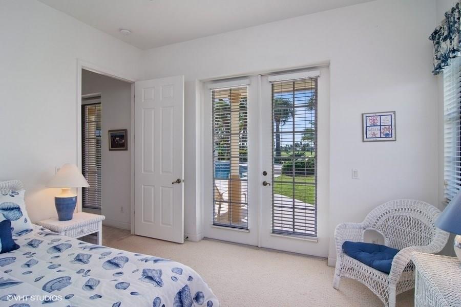 2160 Golfview Lane Stuart, FL 34996 - Photo 15 of 39 a bedroom with a bed and wooden floor