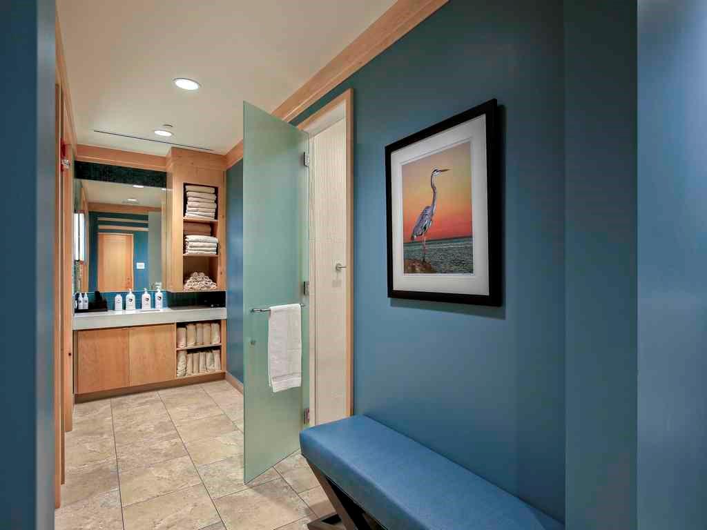 2160 Golfview Lane Stuart, FL 34996 - Photo 34 of 39 a view of a hallway with wooden floor and a bathroom