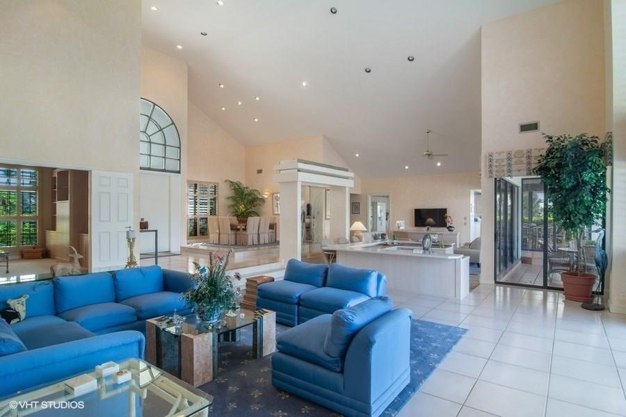 2160 Golfview Lane Stuart, FL 34996 - Photo 6 of 39 a living room with furniture a rug kitchen view and a large window