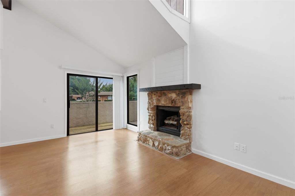 141 Spring Wind Way Casselberry, FL 32707 - Photo 12 of 32 a view of an empty room with wooden floor and a fireplace