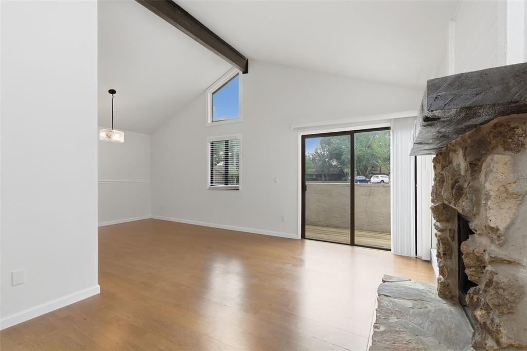141 Spring Wind Way Casselberry, FL 32707 - Photo 13 of 32 a view of a big room with windows and chandelier