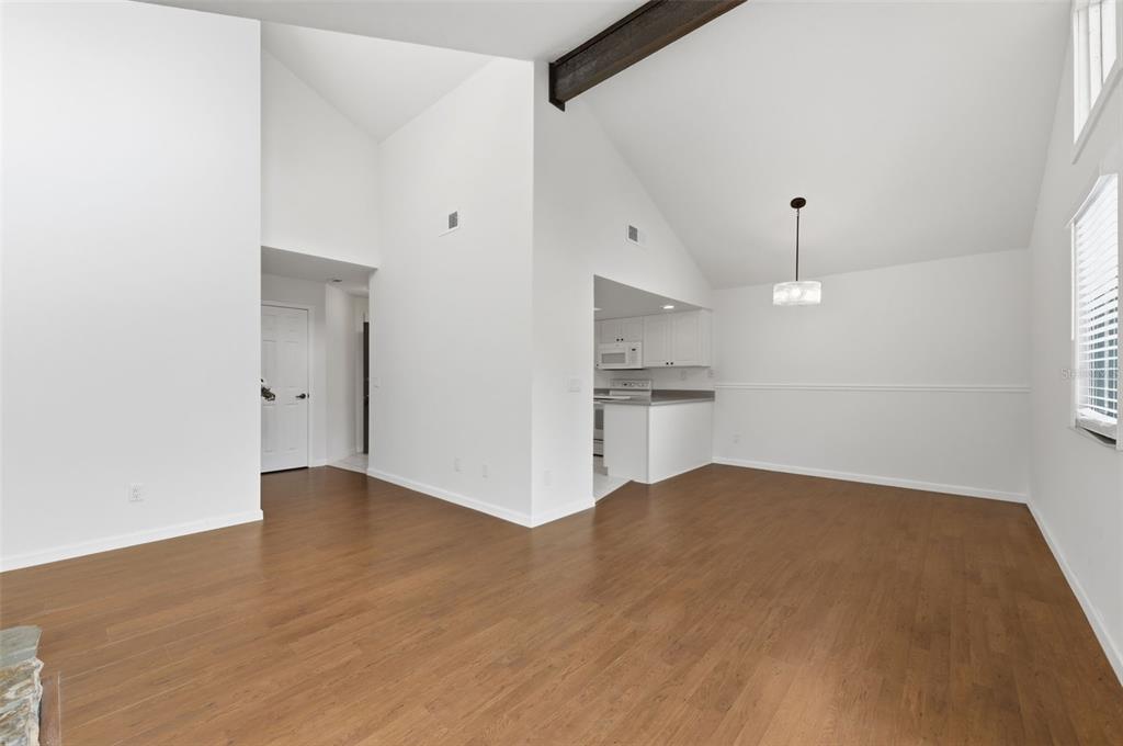 141 Spring Wind Way Casselberry, FL 32707 - Photo 14 of 32 a view of kitchen and empty room with wooden floor